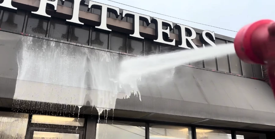 Commercial soft wash foam on a storefront facade in Jacksonville, FL