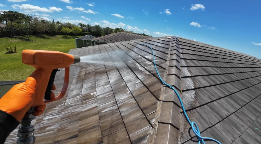 Soft wash foam applied to black algae streaks on tile roof in Jacksonville, FL